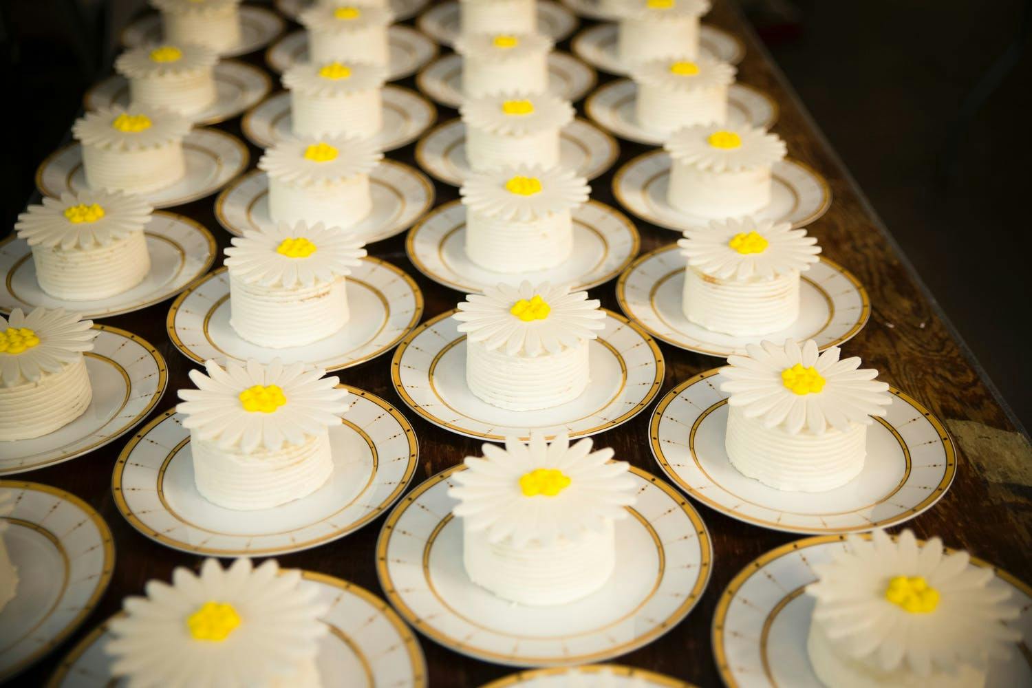 Individual cakes covered in a daisy flower for anniversary party | PartySlate