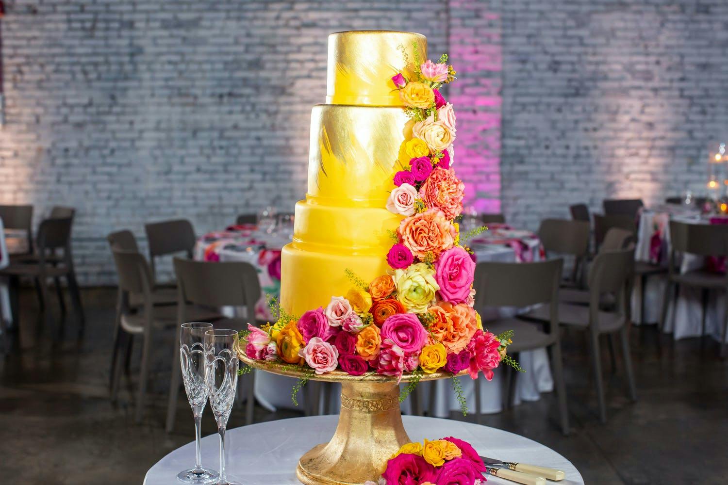 Gold Wedding Cake With Bright and Colorful Flowers | PartySlate