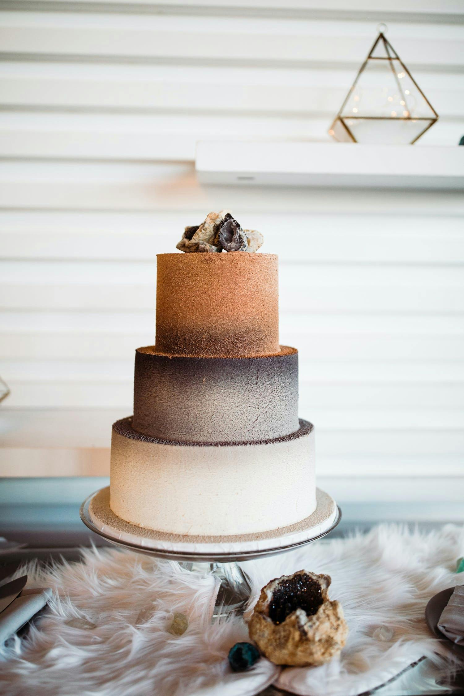 Three tier wedding cake with dusty orange, grey and white using gradient effect | PartySlate