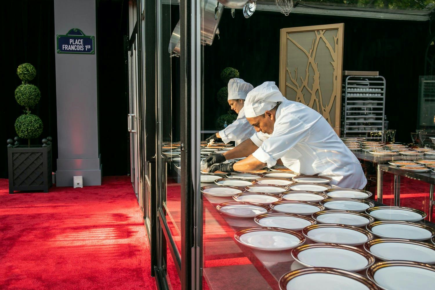 Glass panel that allows guests to see chefs preparing food for 50th anniversary party | PartySlate