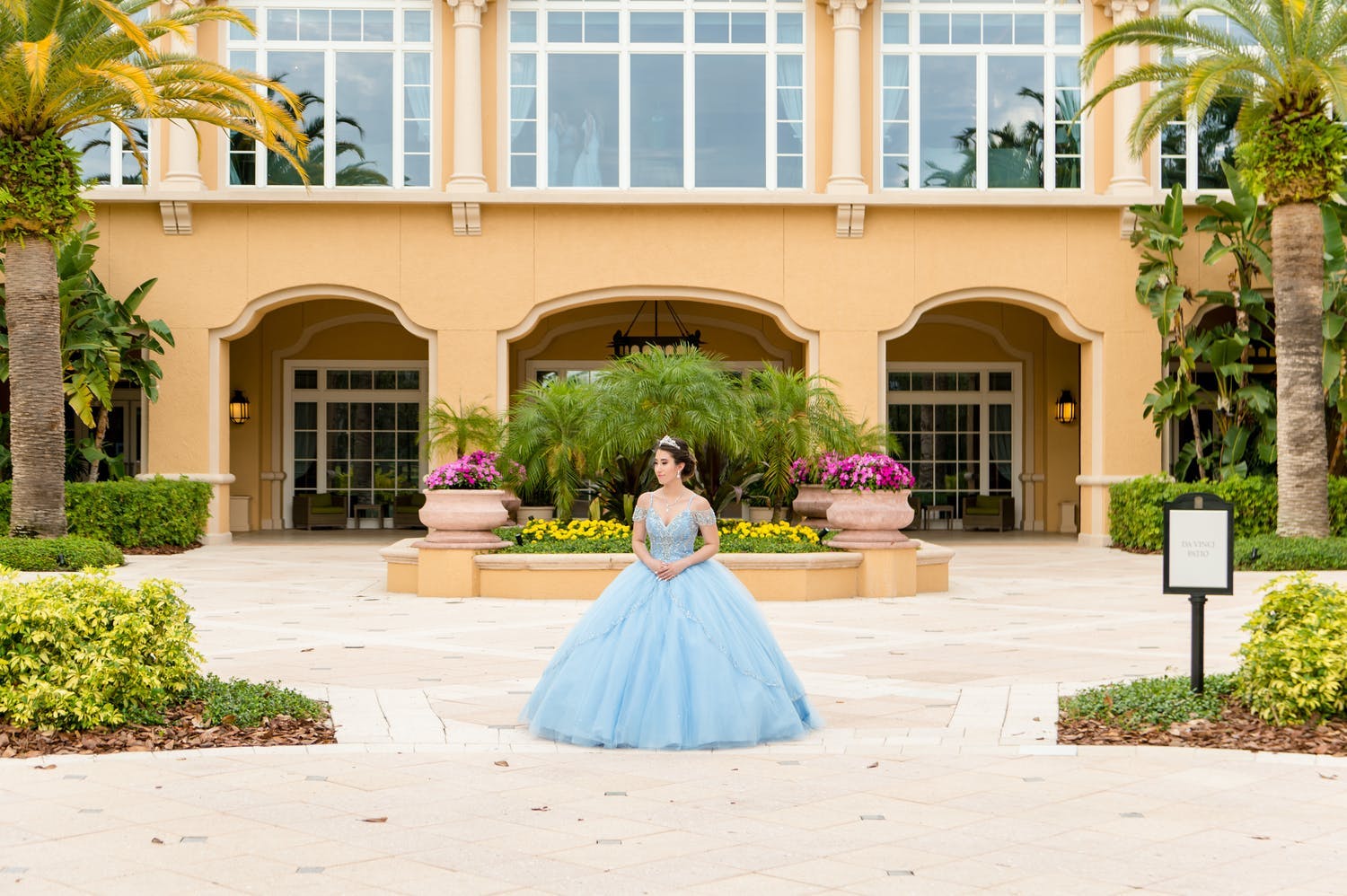 Quinceañera stands in front of The Ritz-Carlton Orlando, Grande Lakes, her reception venue | PartySlate
