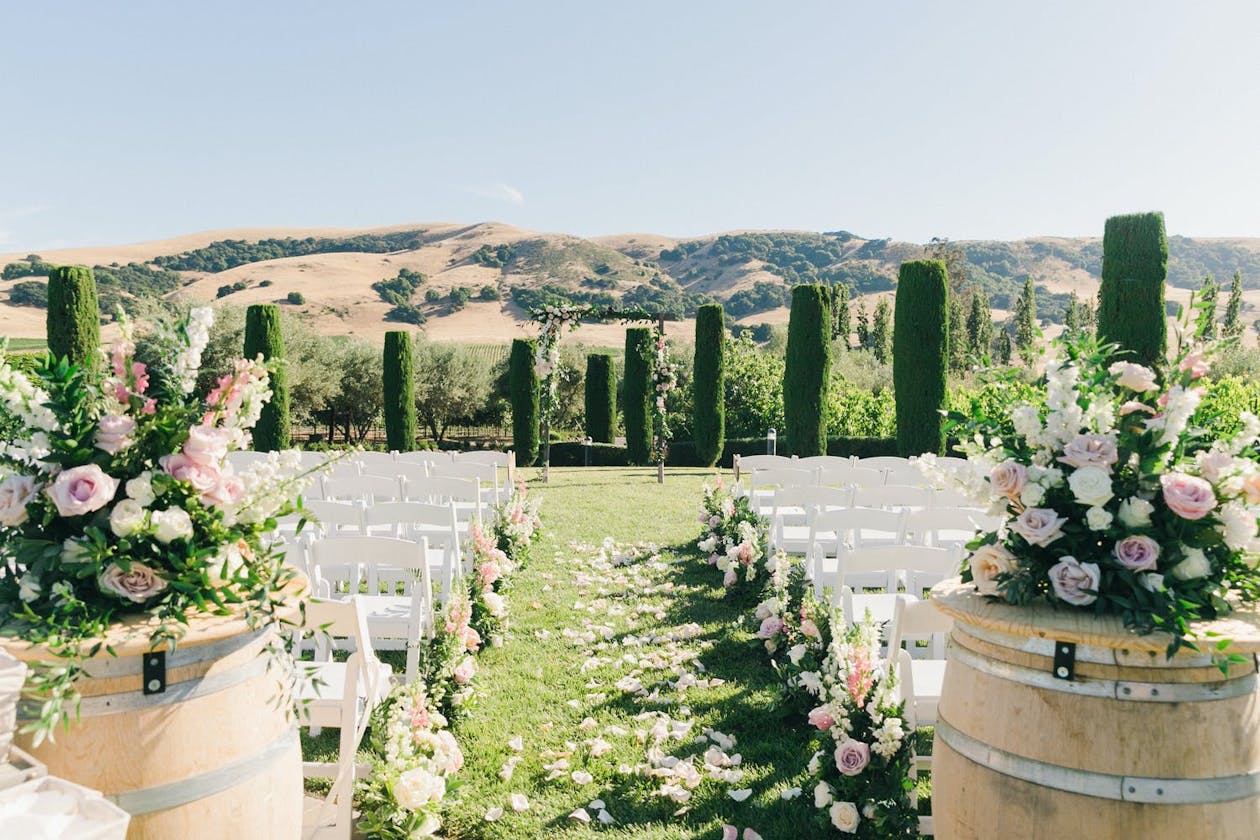 Pink and White Romantic Outdoor Ceremony at Viansa Sonoma, One of the Premier Winery Wedding Venues | PartySlate