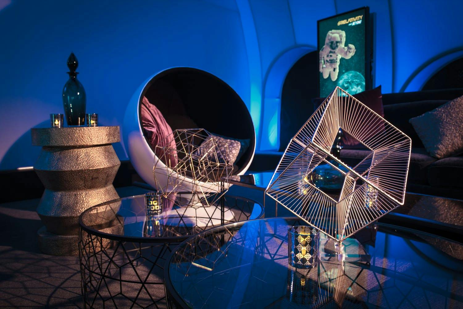 Futuristic lounge area with geometric décor at space-themed corporate holiday party | PartySlate
