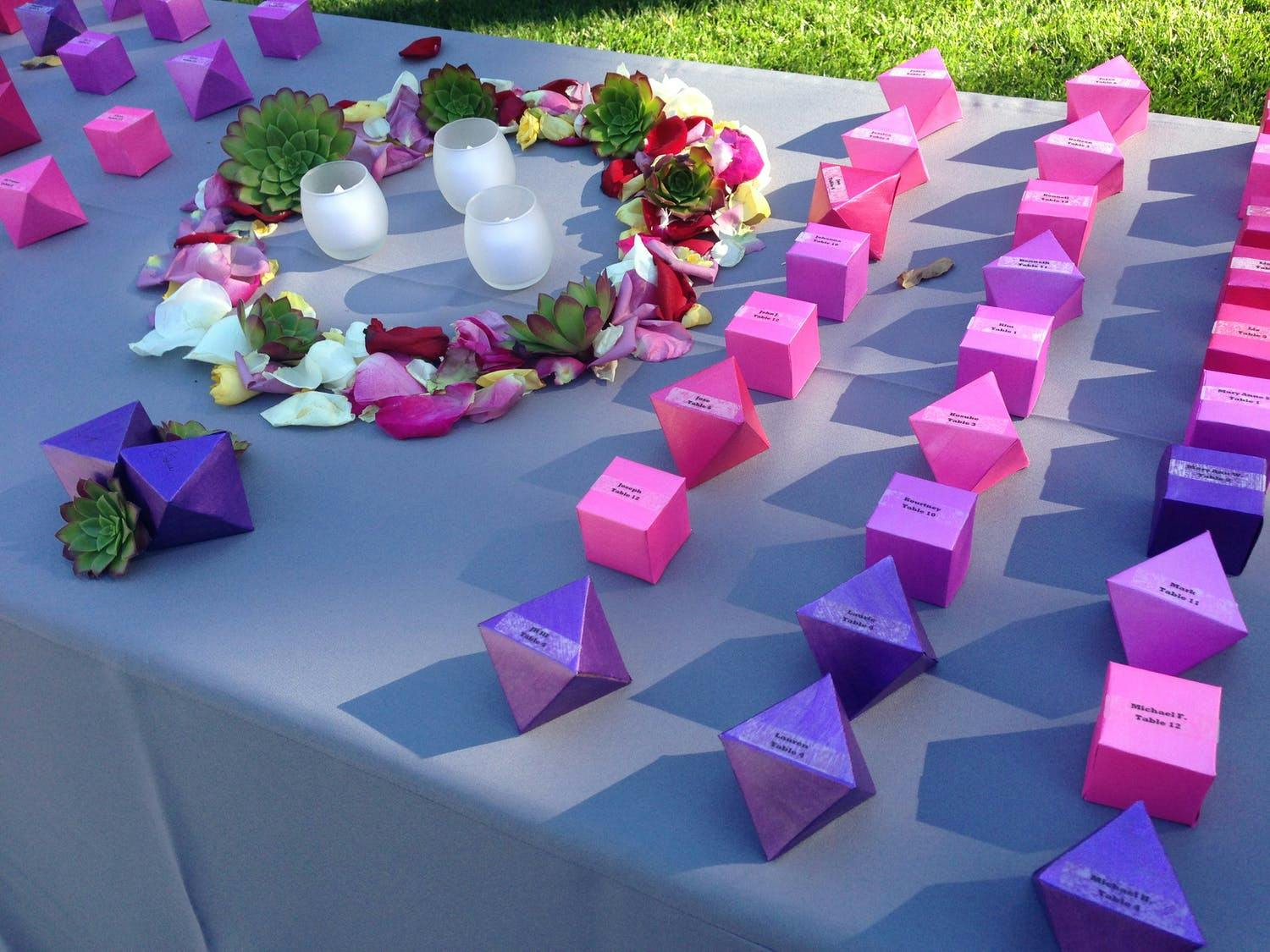 Garden wedding with pink and purple geometric origami wedding escort cards | PartySlate