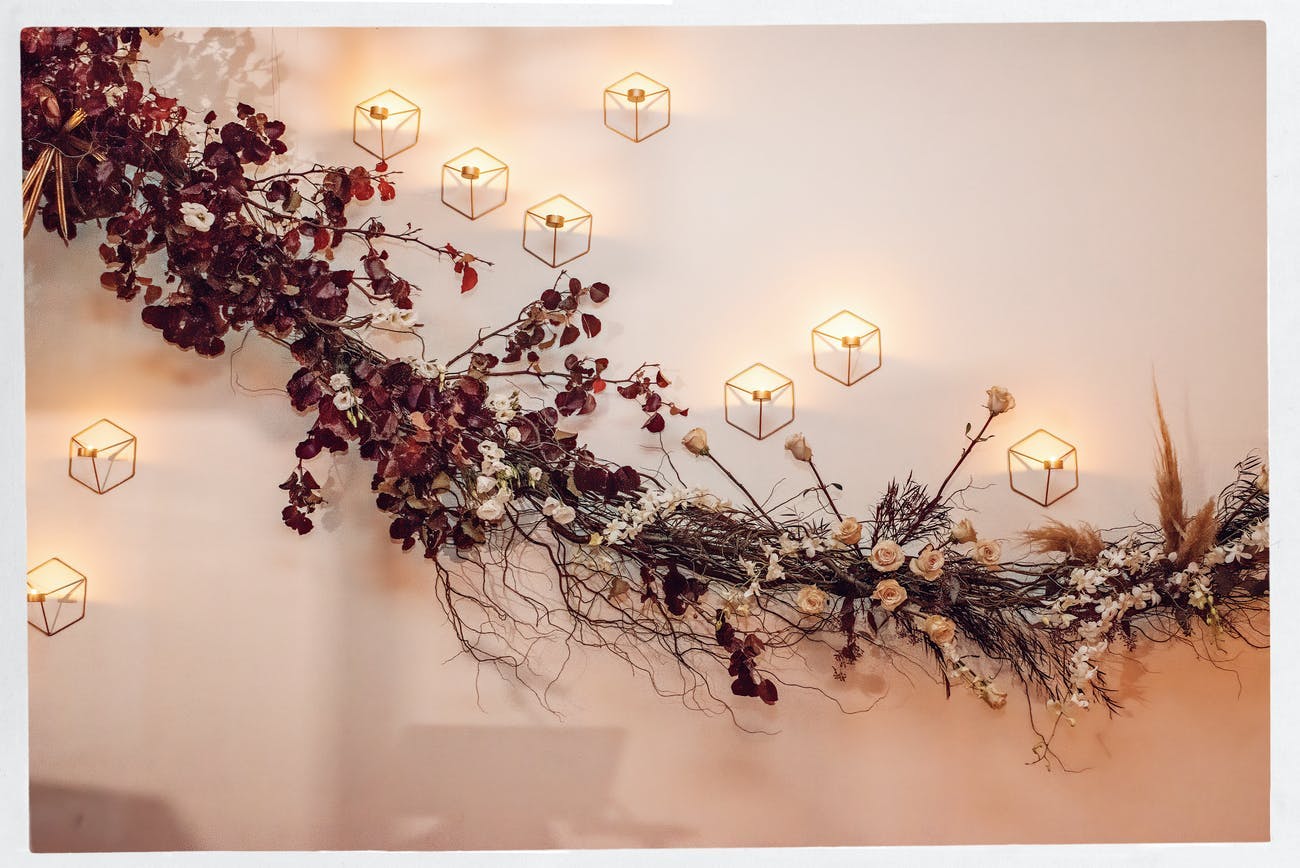 Ikebana-style fall wedding ceiling décor | PartySlate