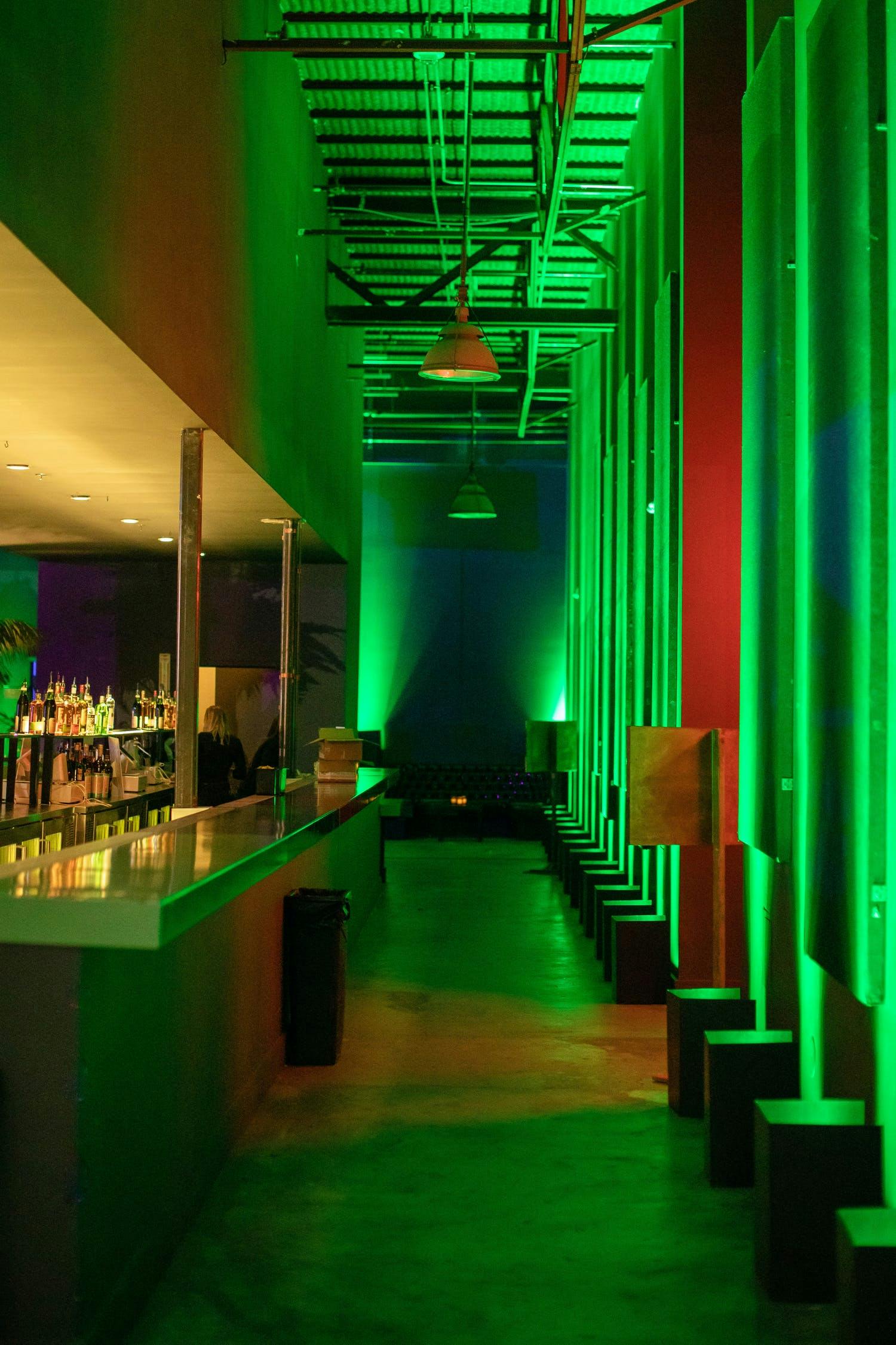 Corporate holiday party in San Francisco with red and green uplighting | PartySlate