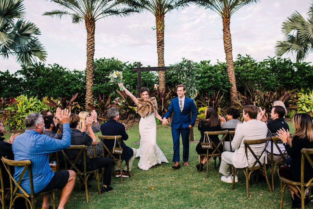 Tuscany-inspired wedding recessional of bride and groom | PartySlate