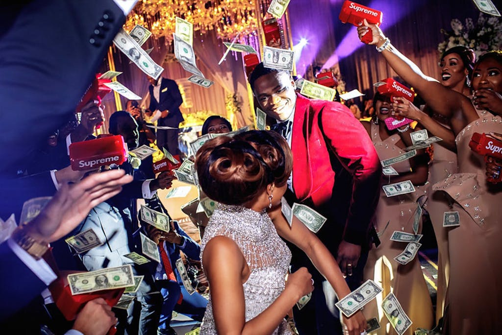 Money spray at vibrant Nigerian-American wedding at Royal Sonesta Houston | PartySlate