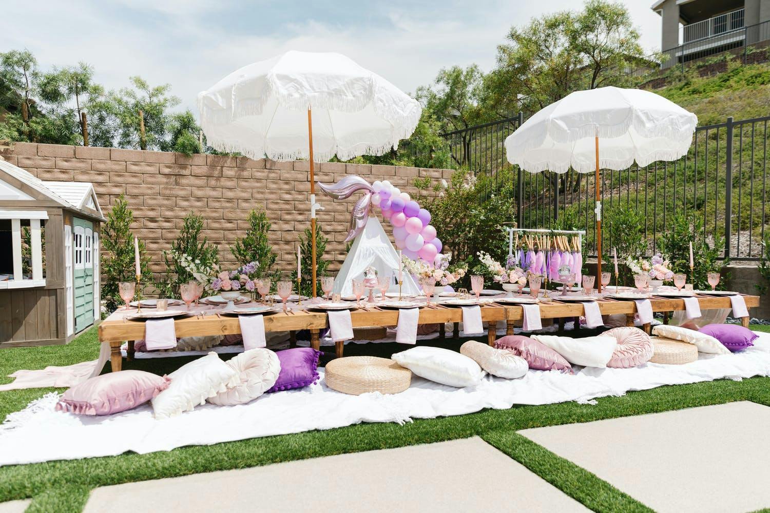 Purple and white mermaid-themed 5th-birthday party with pillow seating | PartySlate