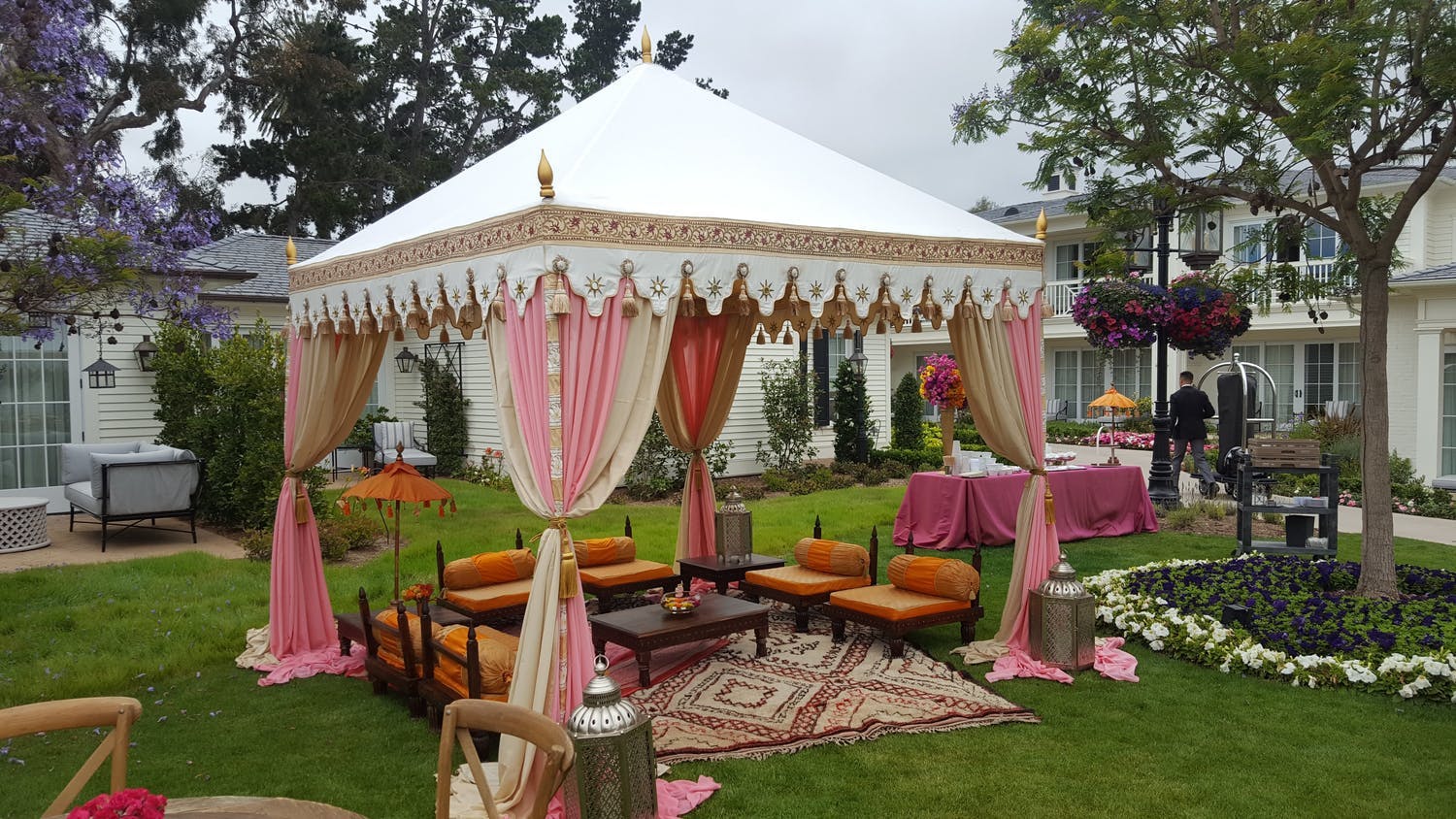 Outdoor Henna Tea at Rosewood Miramar Beach with white and pink marquee tenting | PartySlate