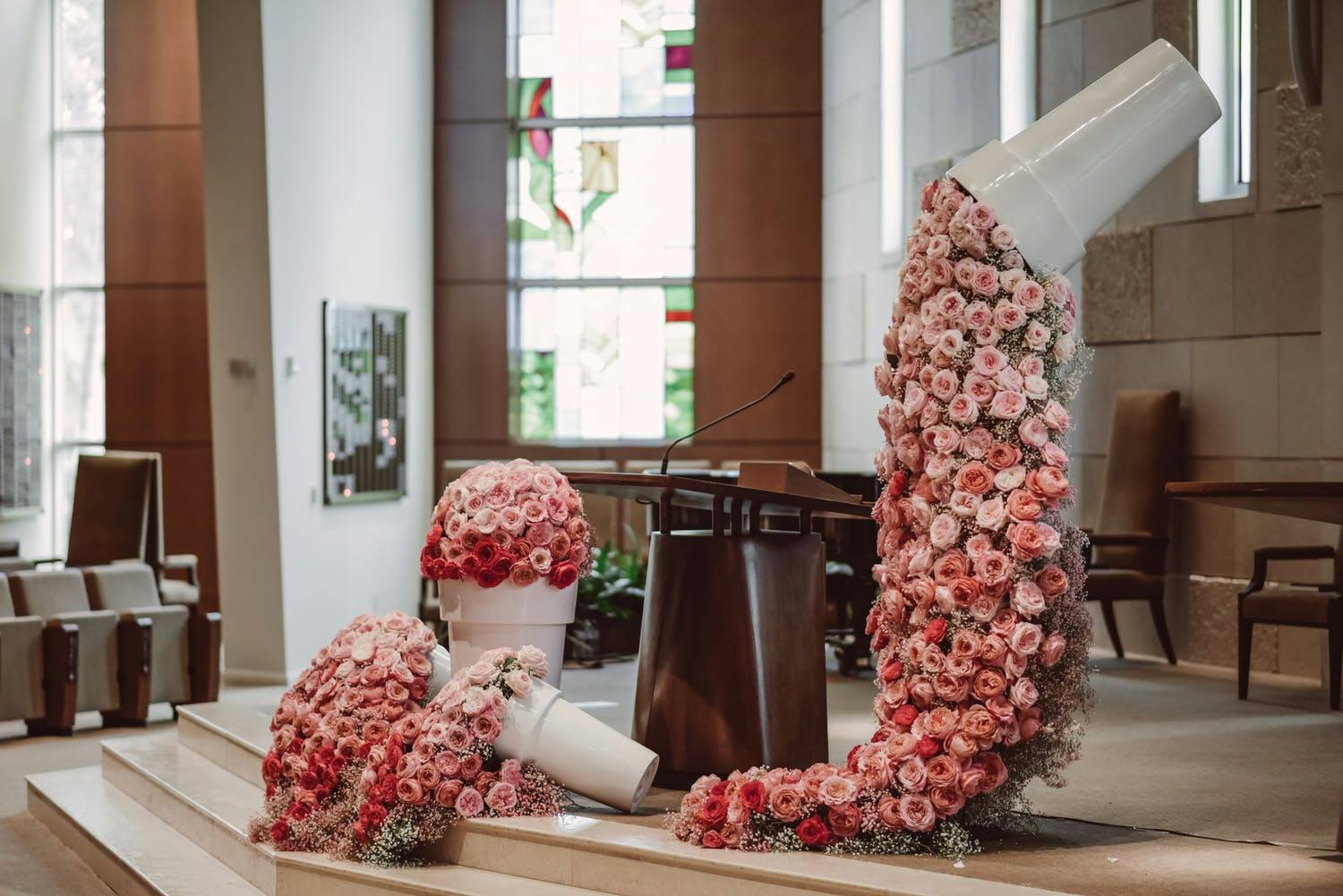 Bimah with Overflowing Potted Plant Pink Floral Décor for Bat Mitzvah | PartySlate