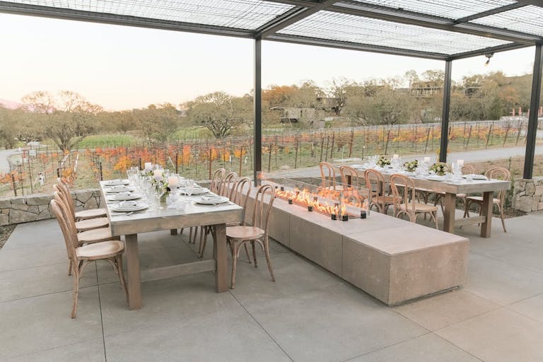 Tables Next To a Glass Fireplace Looking At Vineyards | PartySlate