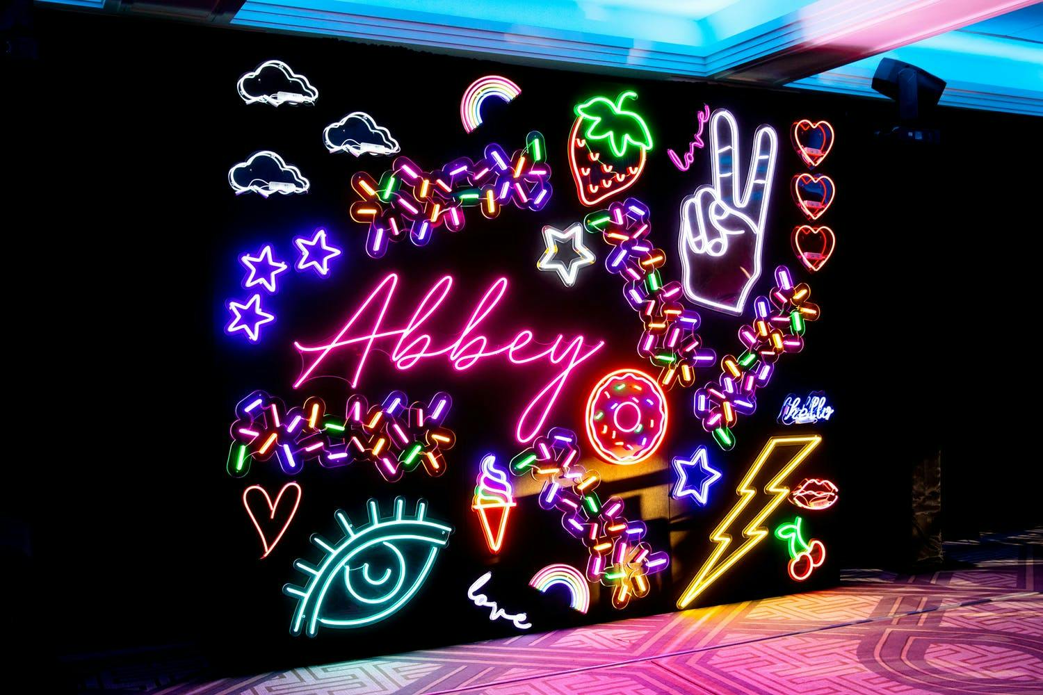 Neon-Themed Bat Mitzvah Signage With Peace Sign, Strawberry, Clouds Icons, and More | PartySlate