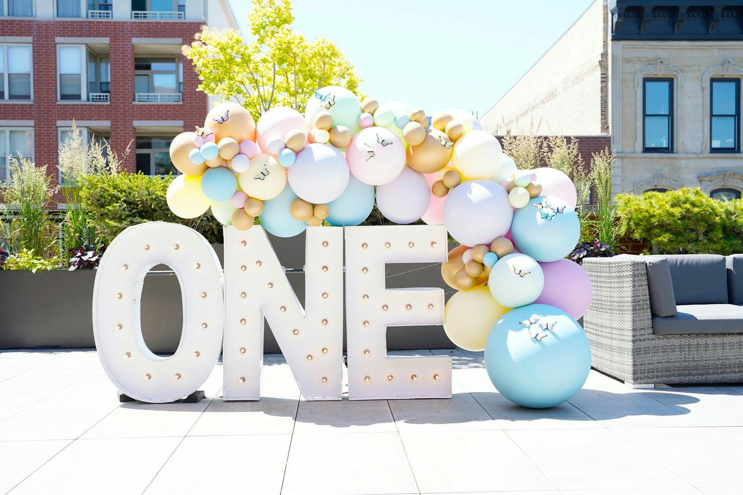 Butterfly-themed 1st-birthday party balloon installation and signage | PartySlate