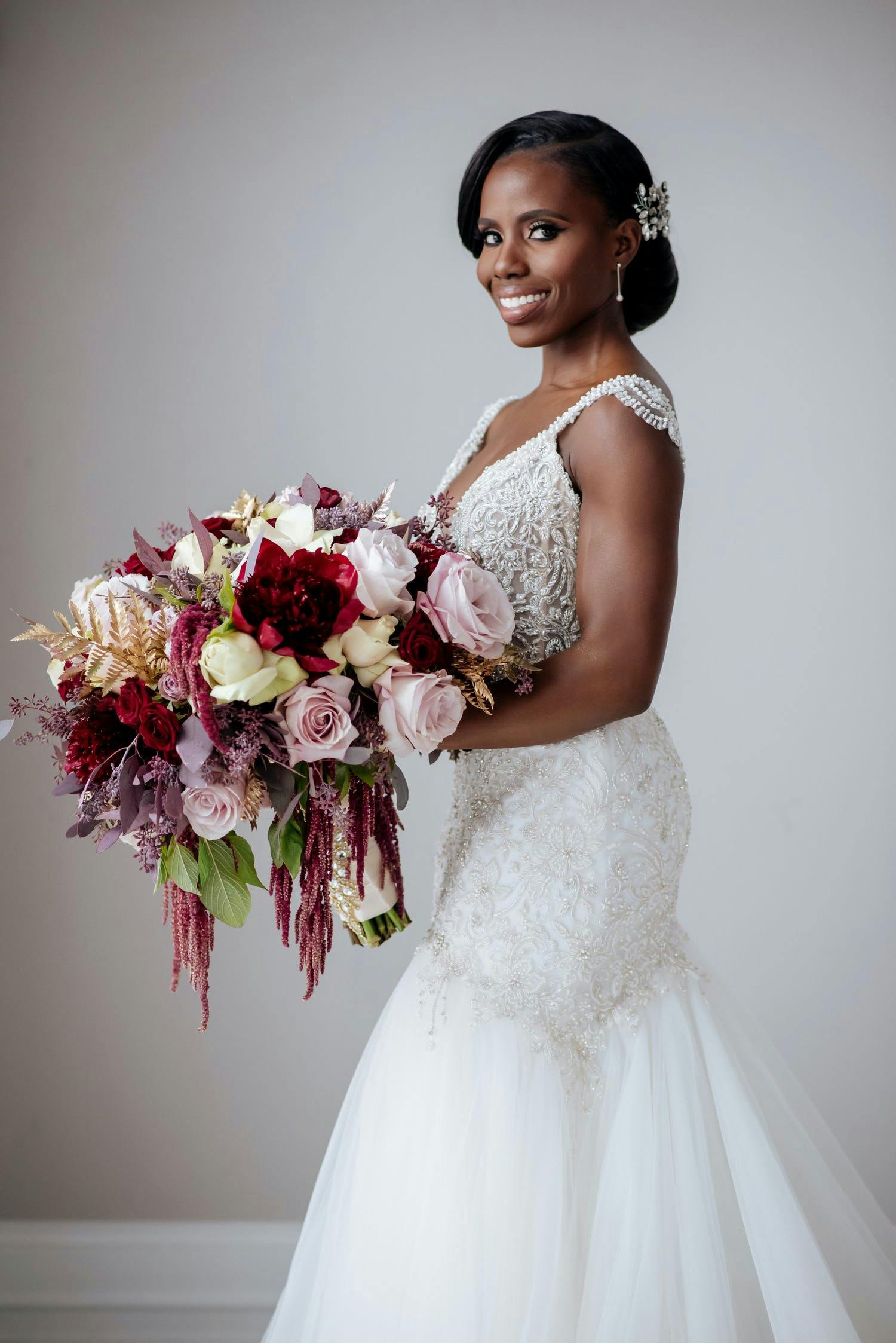 Bride holds fall wedding bouquet by BCG Events of Washington D.C. | PartySlate