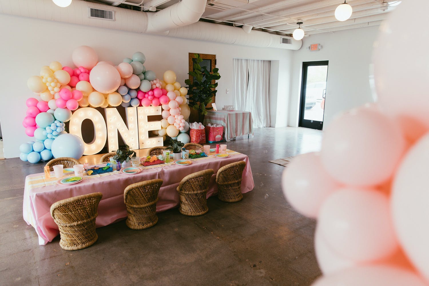 Boho-themed first birthday party with miniature rattan throne seating | PartySlate