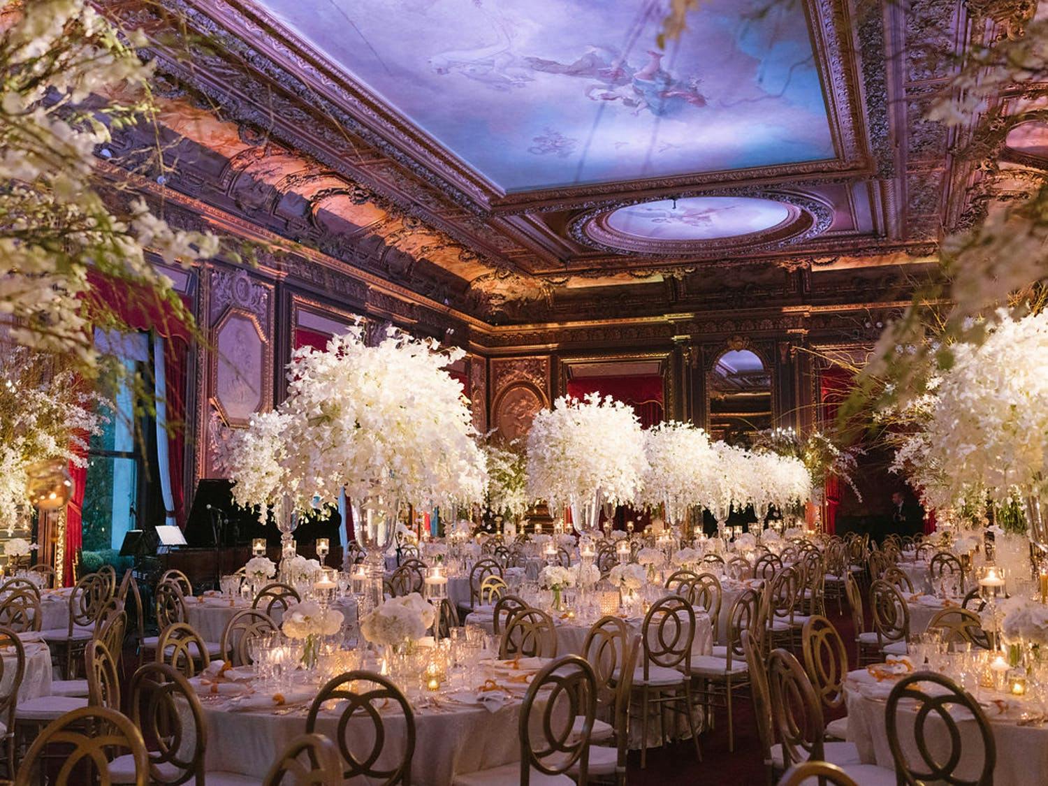 Glamorous wedding at The Metropolitan Club with centerpieces in white winter wedding color palette | PartySlate