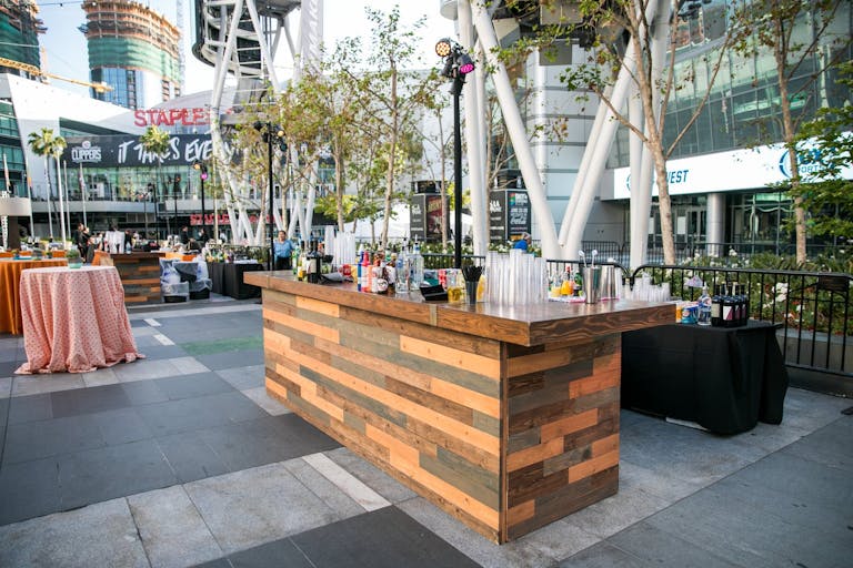 Outdoor corporate picnic with wooden bar set up at Microsoft Square at L.A. LIVE in Los Angeles, CA | PartySlate