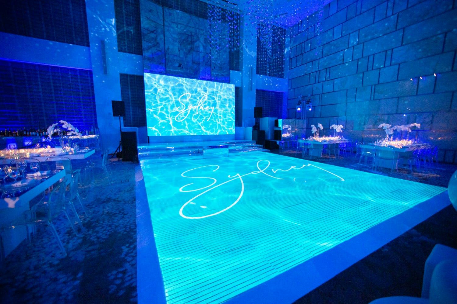 Pool Party Bat Mitzvah Theme with Blue Uplighting and LED Dance Floor | PartySlate