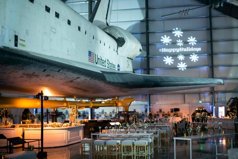 Company holiday party at Samuel Oschin Space Shuttle Endeavour Pavilion at California Science Center | PartySlate at