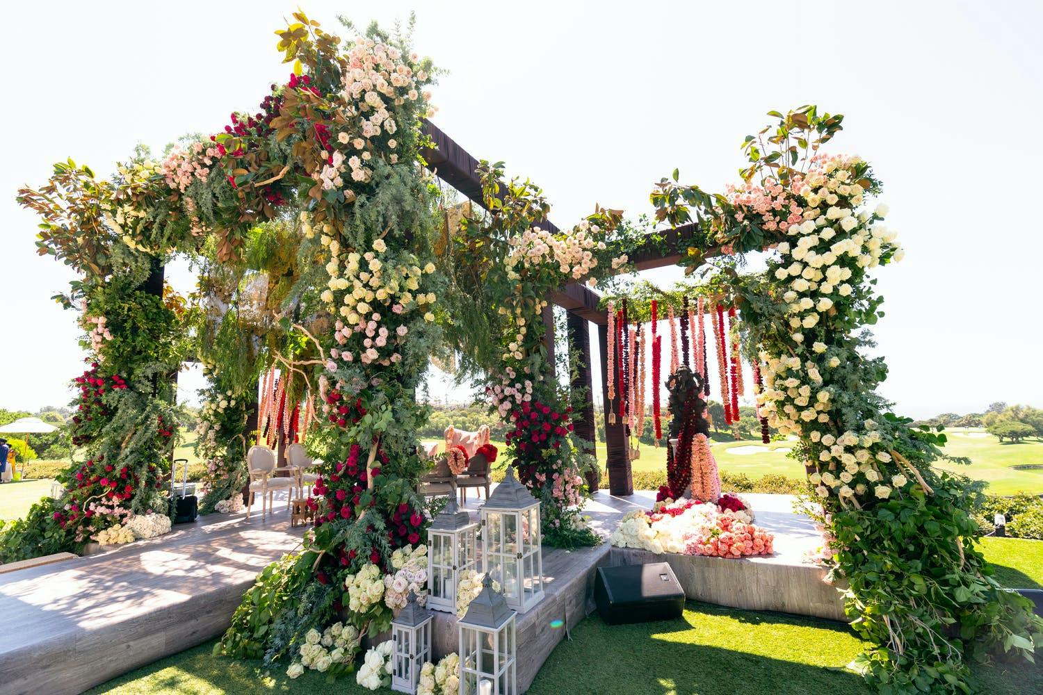 Wedding mandap with wild greenery and branches | PartySlate