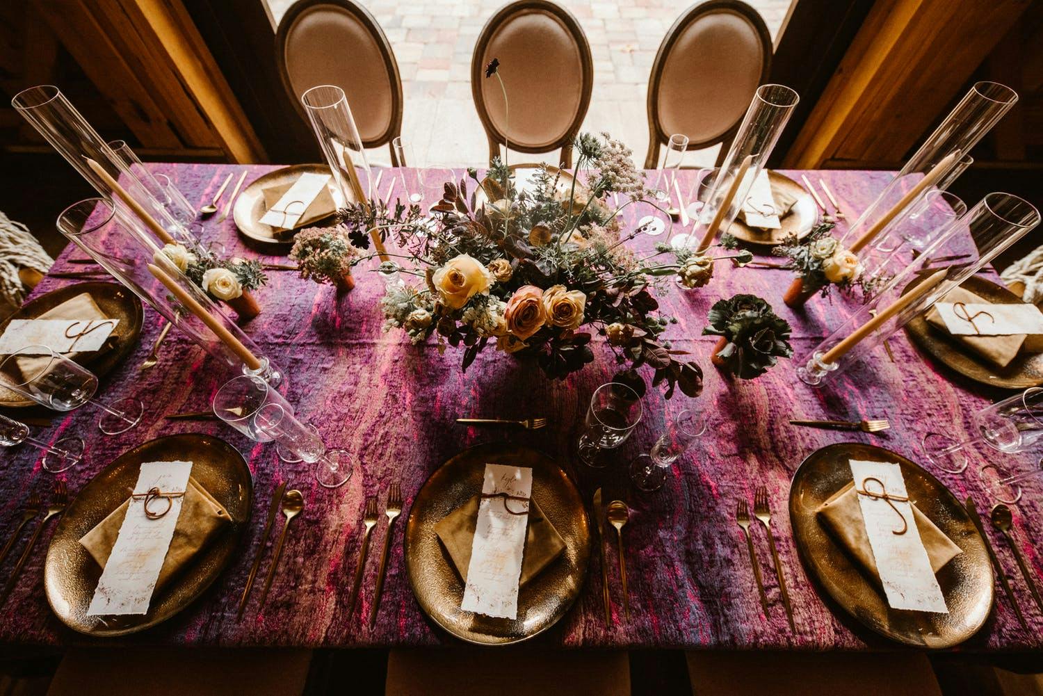 Intimate autumn tablescape with marbled mauve and plum linen along with copper accents | PartySlate