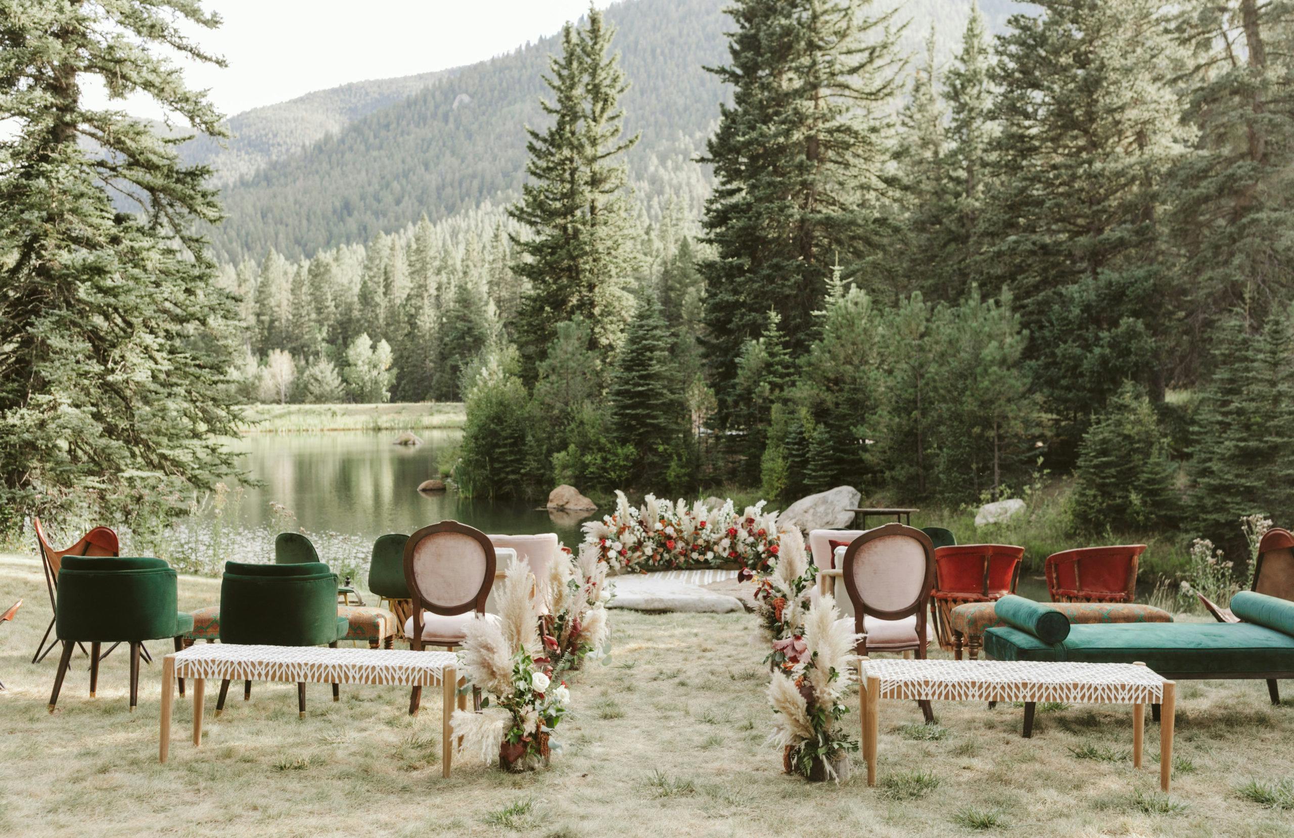 A fall wedding ceremony filled with eclectic velvet furniture in a forest setting | PartySlate