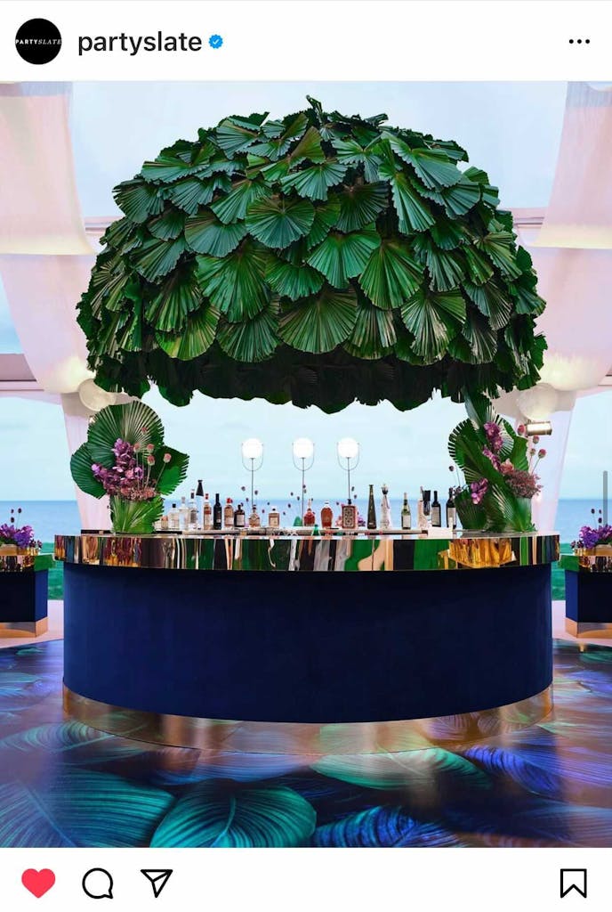 A tropical outdoor Bat Mitzvah party with a chic tent design and tropical bar set up | PartySlate