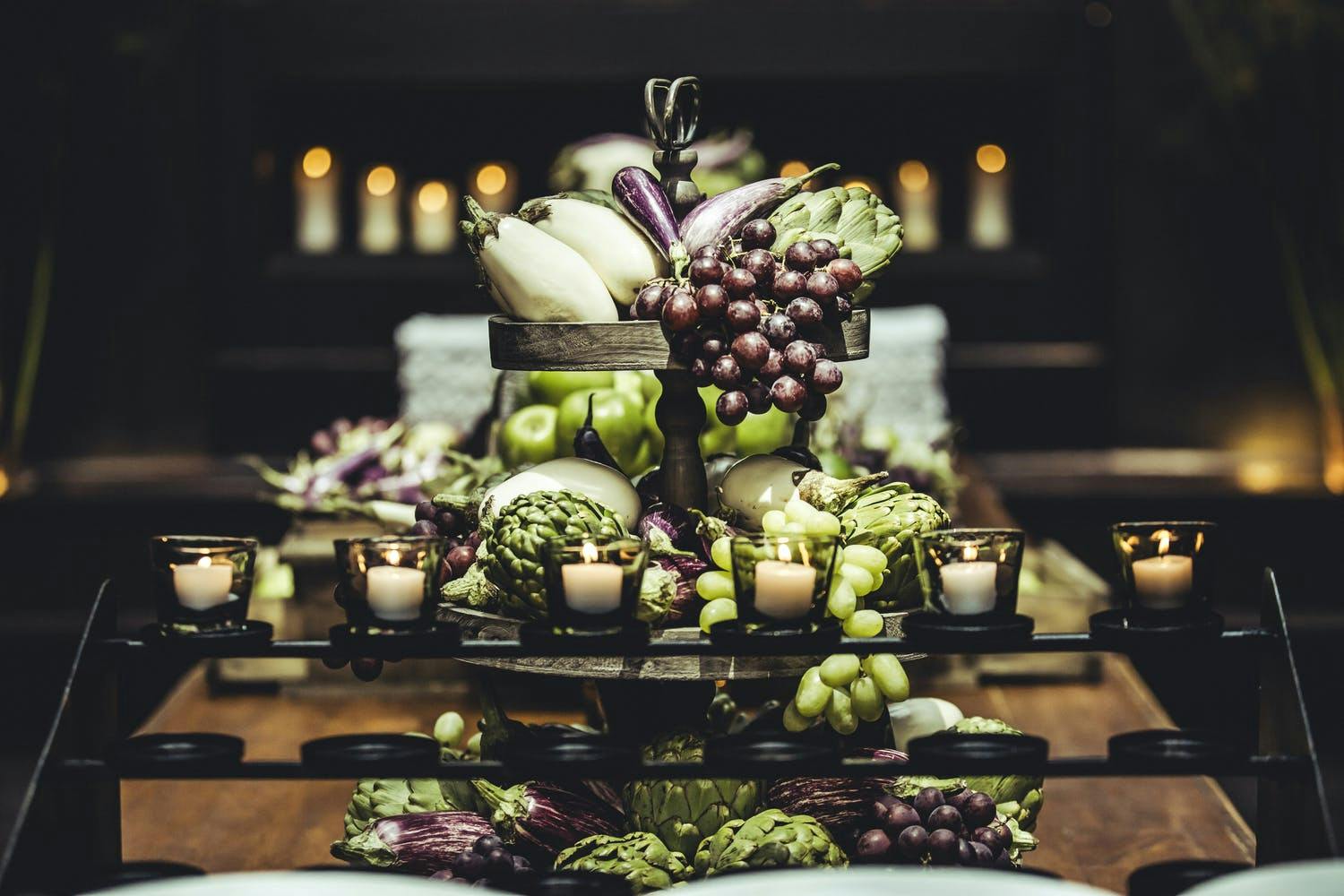 Eggplant, artichoke & grape wedding centerpiece | PartySlate