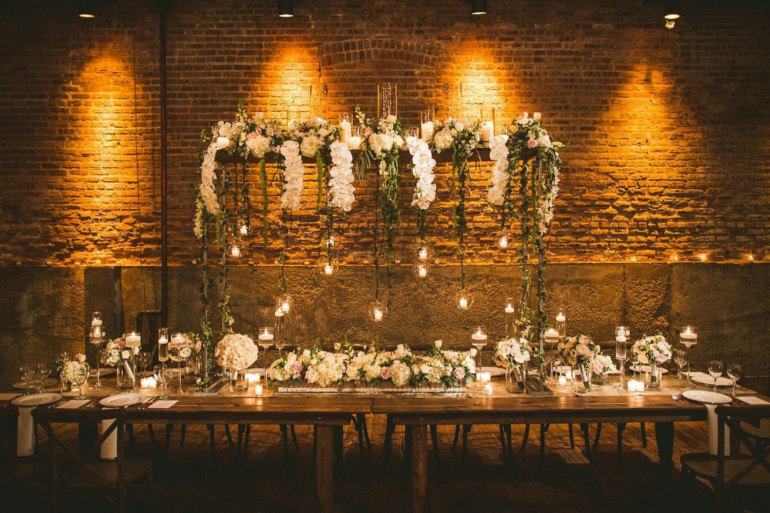 Industrial rustic winter wedding centerpieces with greenery and white orchids | PartySlate
