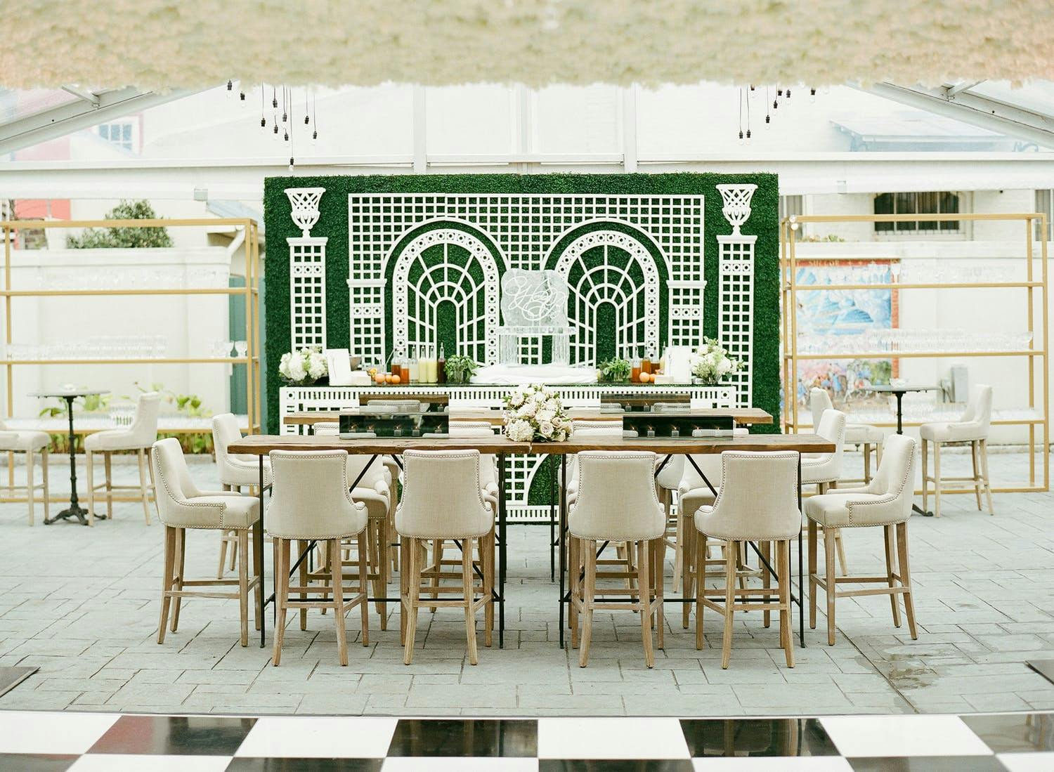 Tented wedding with boxwood backdrop with white garden design | PartySlate