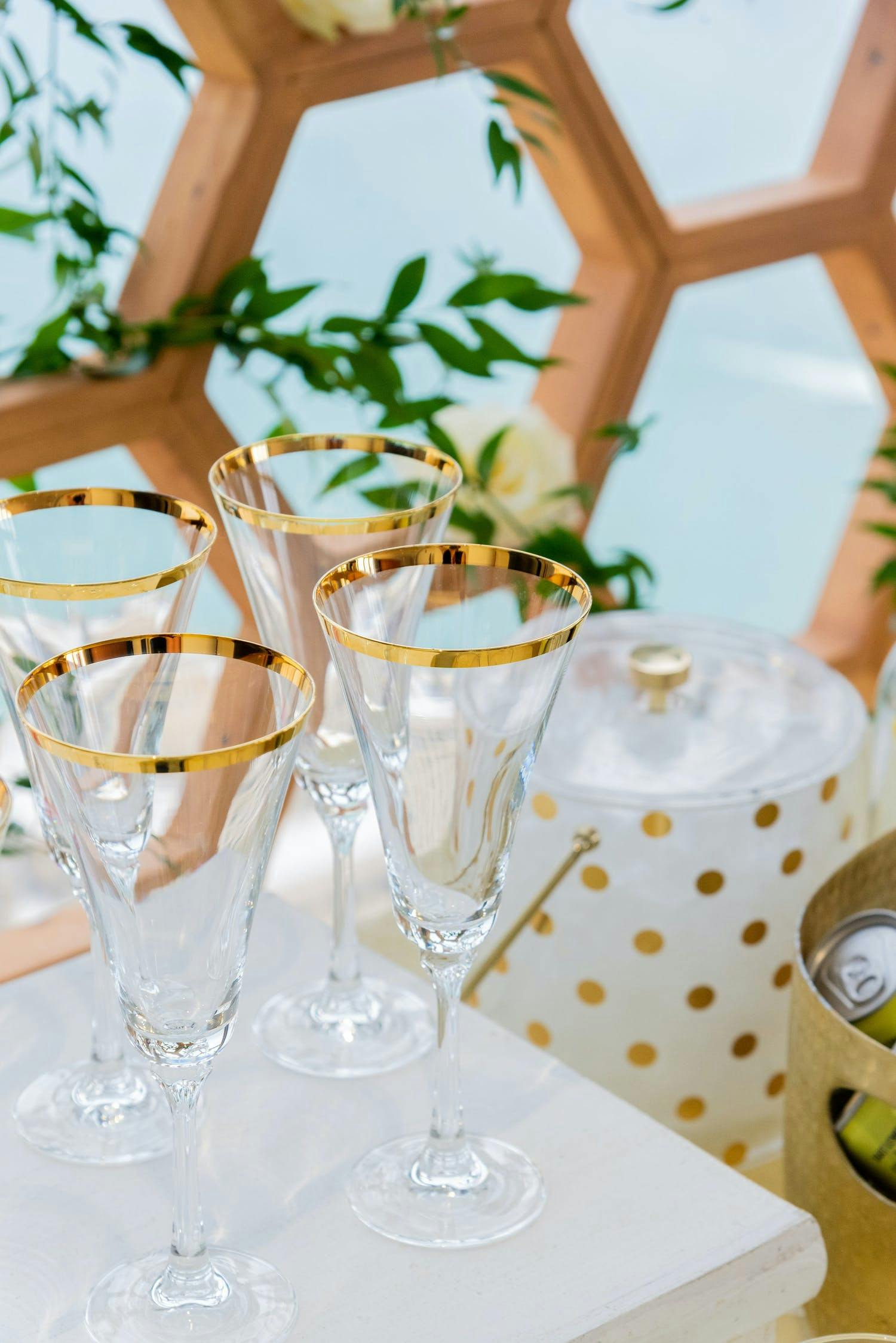Honey Bee Themed Party With Gold Rimmed Champagne Glasses and Gold Accents | PartySlate