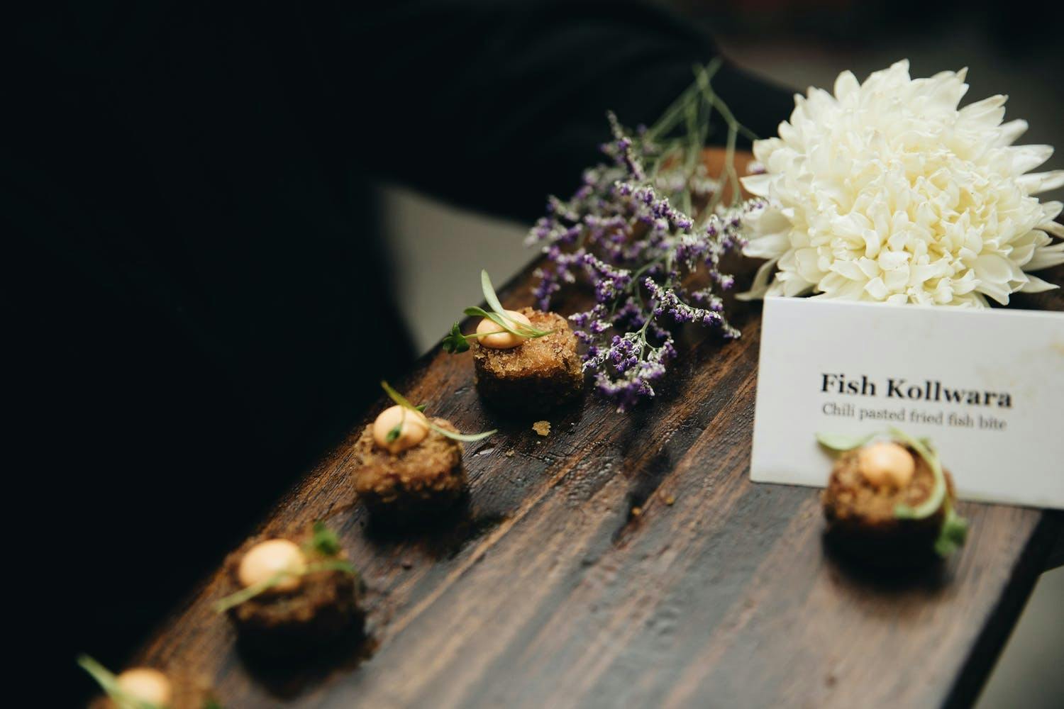 Fish Kollara with descriptive signage | PartySlate