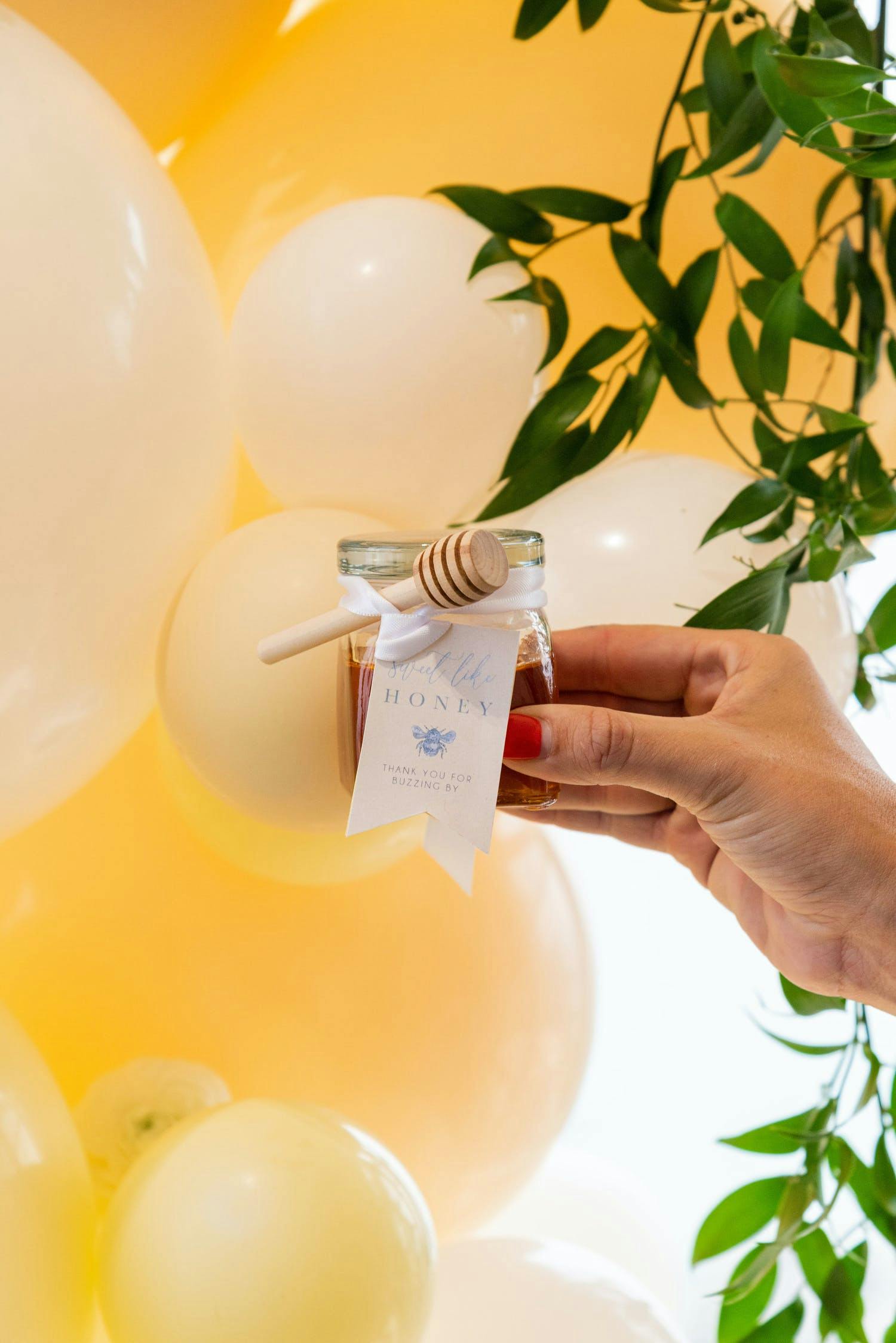 Honey Bee Themed Party With Mini Honey Jars and Yellow and White Balloons | PartySlate