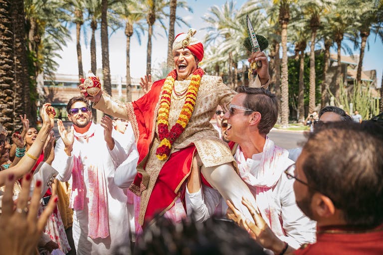 Traditional Colorful Indian Wedding with Groom and Party Entering | PartySlate