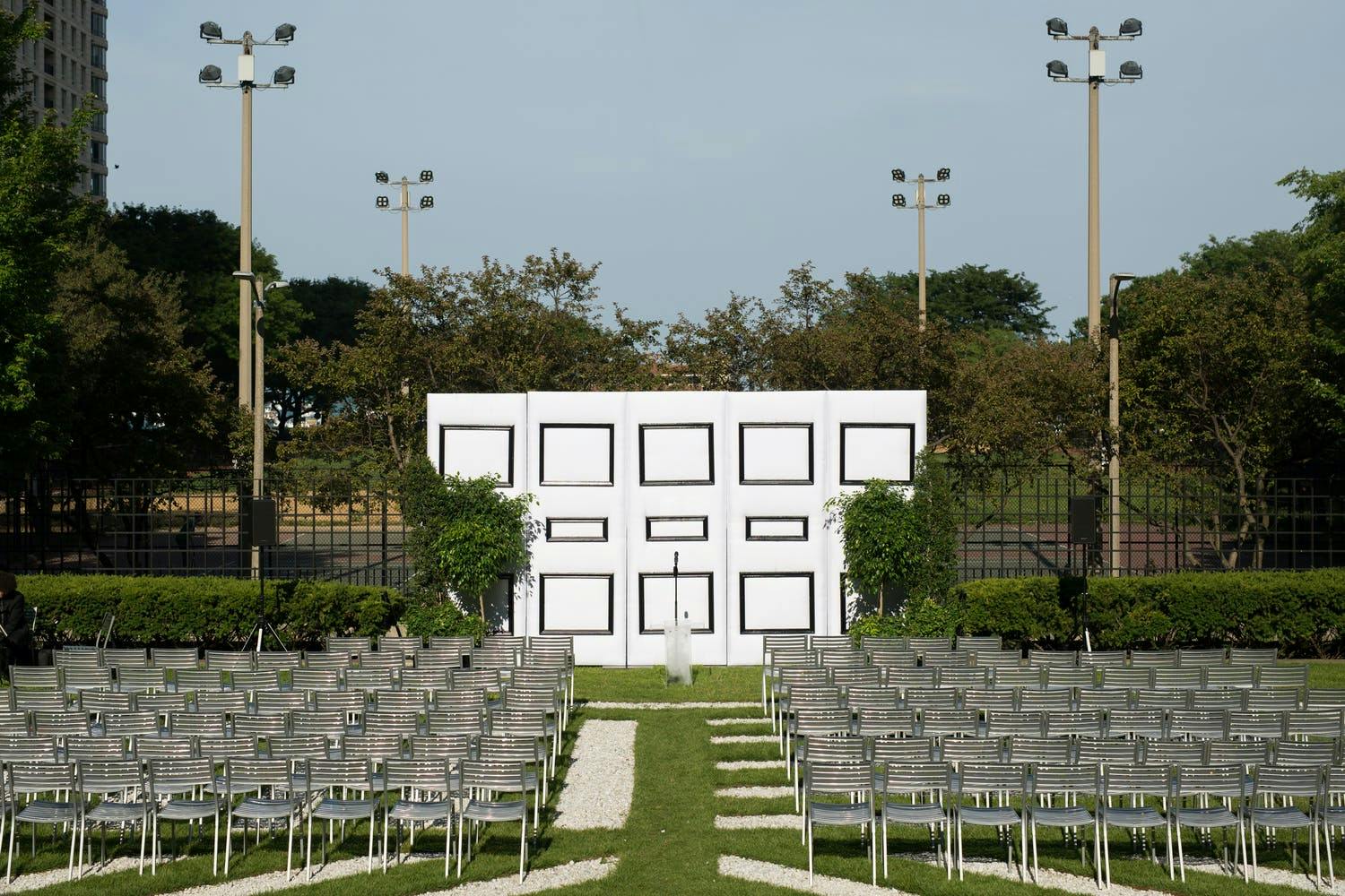 Outdoor wedding at Museum of Contemporary Art Chicago with unique black-and-white geometric ceremonial backdrop | PartySlate