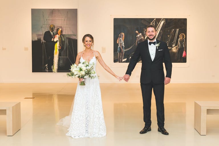 Bride and Groom Holding Hands at 21c Museum Hotel Chicago Hotel Wedding Venue | PartySlate