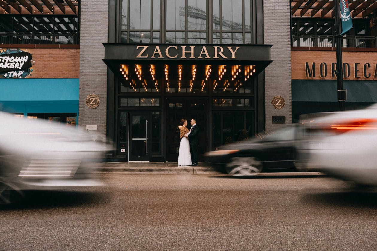 Couple Standing In Front Hotel Zachary Trendy Chicago Hotel Wedding venue with Cars Rushing By | PartySlate