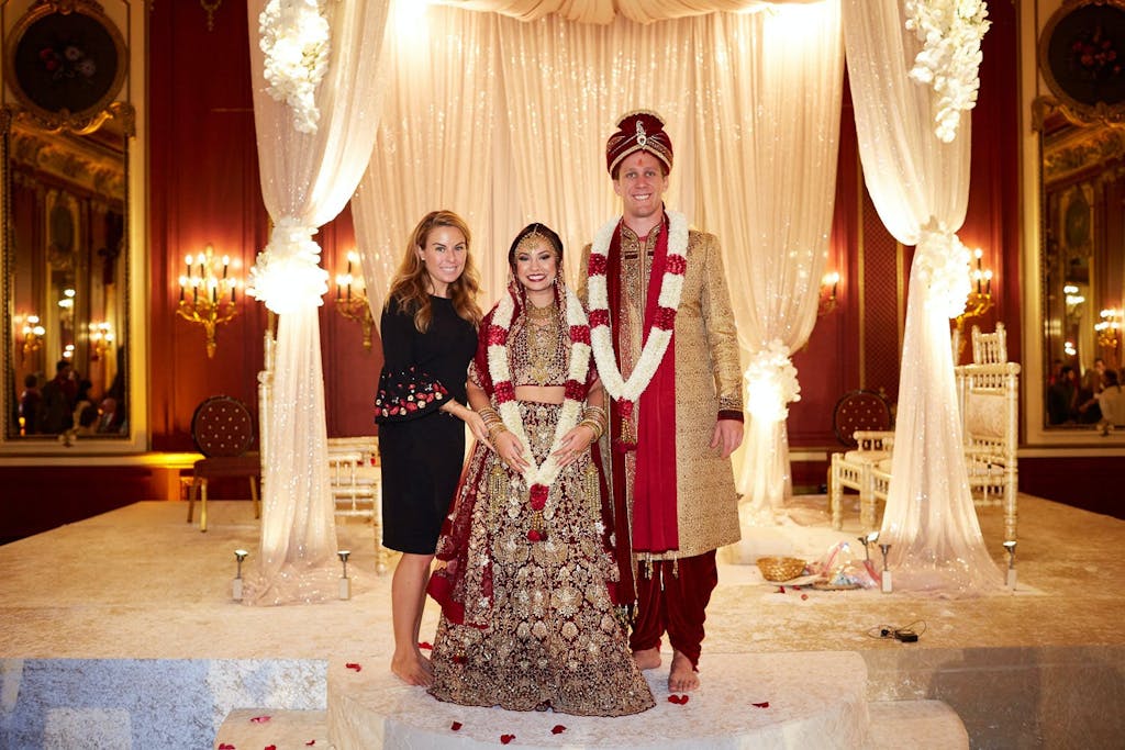 Lead Planner Brianne Garritano of Marquette Avenue Events with couple at multicultural wedding celebration | PartySlate