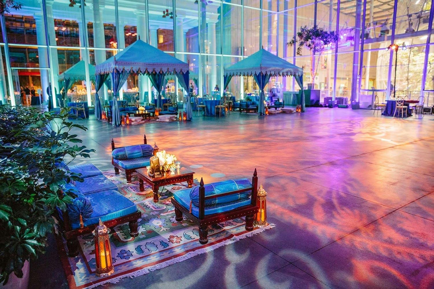 Persian-Indian welcome party with teal pergola tents and purple lighting | PartySlate