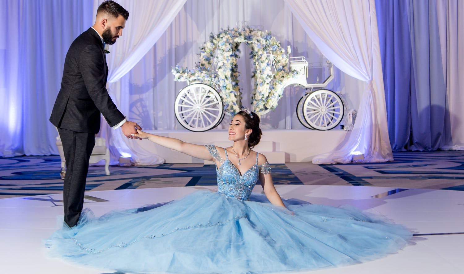 Cinderella-themed quinceañera with timepiece dance floor and carriage backdrop | PartySlate