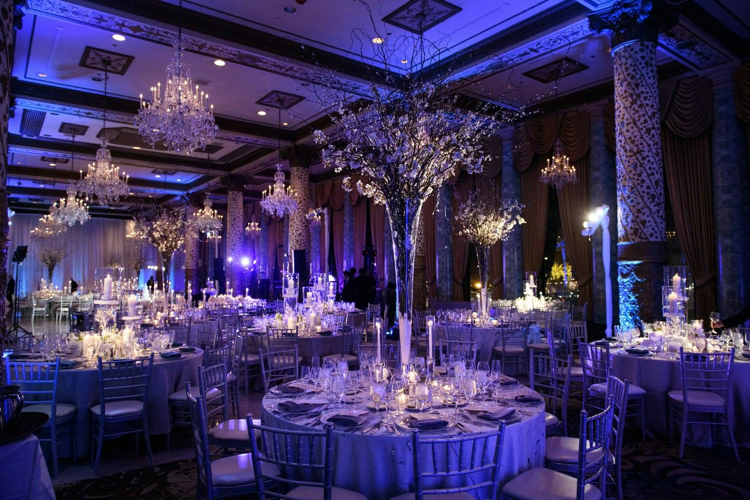 Glamorous winter wedding with purple uplighting and tree branch winter wedding centerpieces at The Drake Hotel | PartySlate