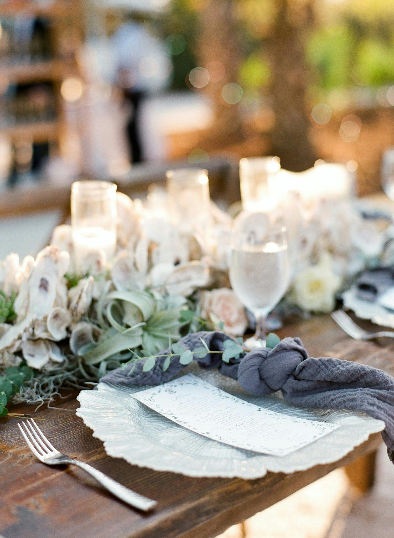 Neutral wedding reception table with succulents and gray-blue napkins