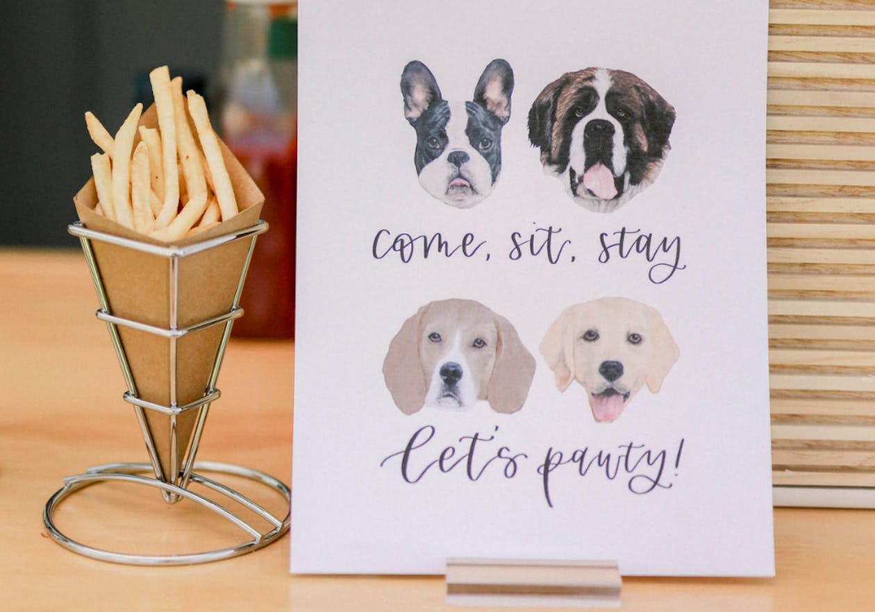 wedding sign with drawings of four dogs | PartySlate