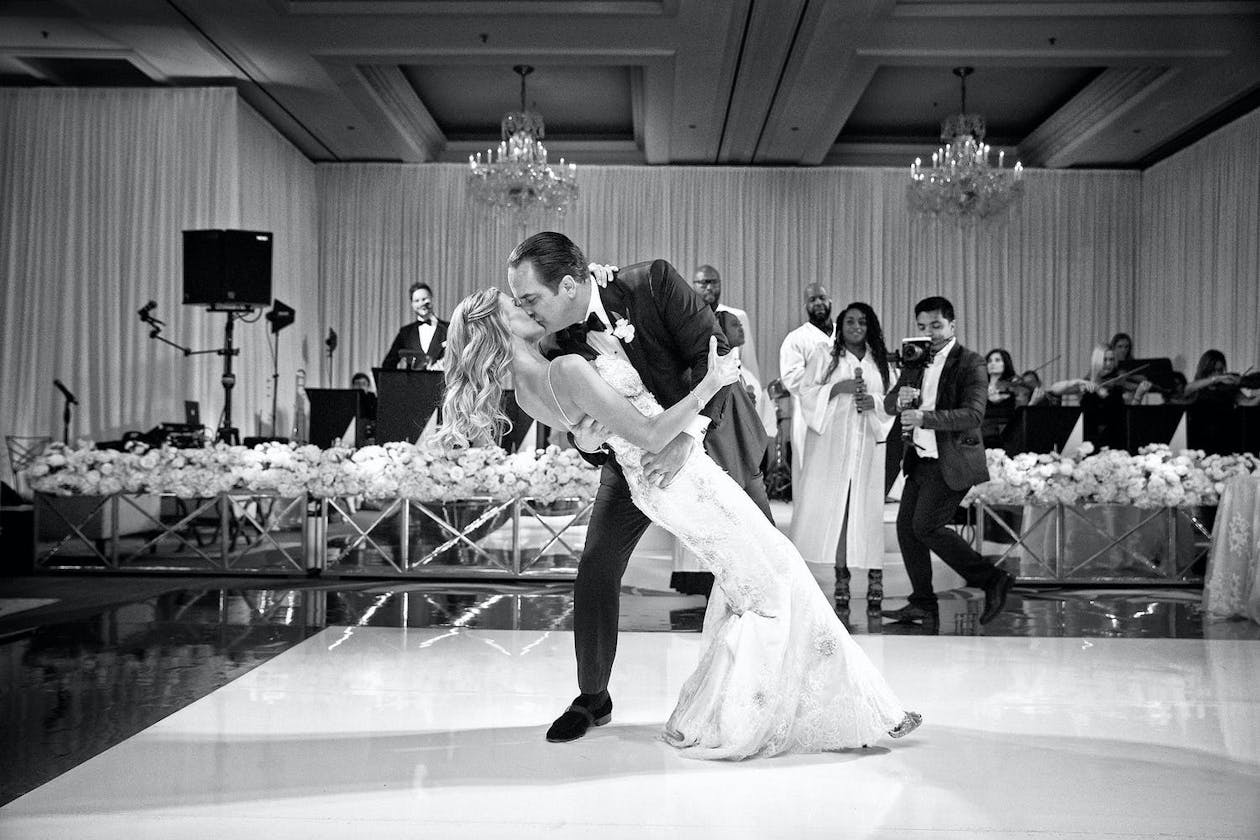 Groom kisses bride during wedding first dance at Four Seasons Hotel Chicago | PartySlate