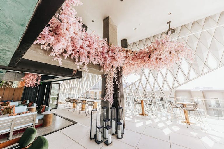 Virgin Hotel Dallas Lobby with Pink Florals and Open Air Seating | PartySlate