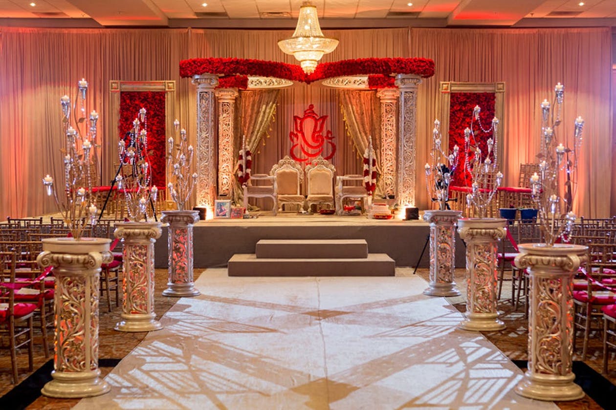 Ornate golden mandap with rose crown and accents | PartySlate