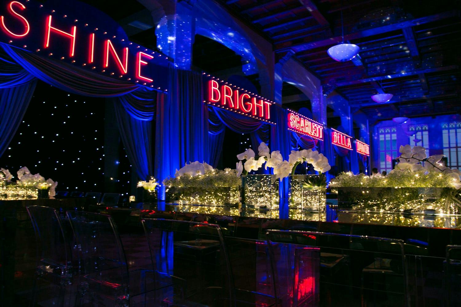 Cirque du Soleil themed Bat Mitzvah party with red neon signage and blue uplighting | PartySlate