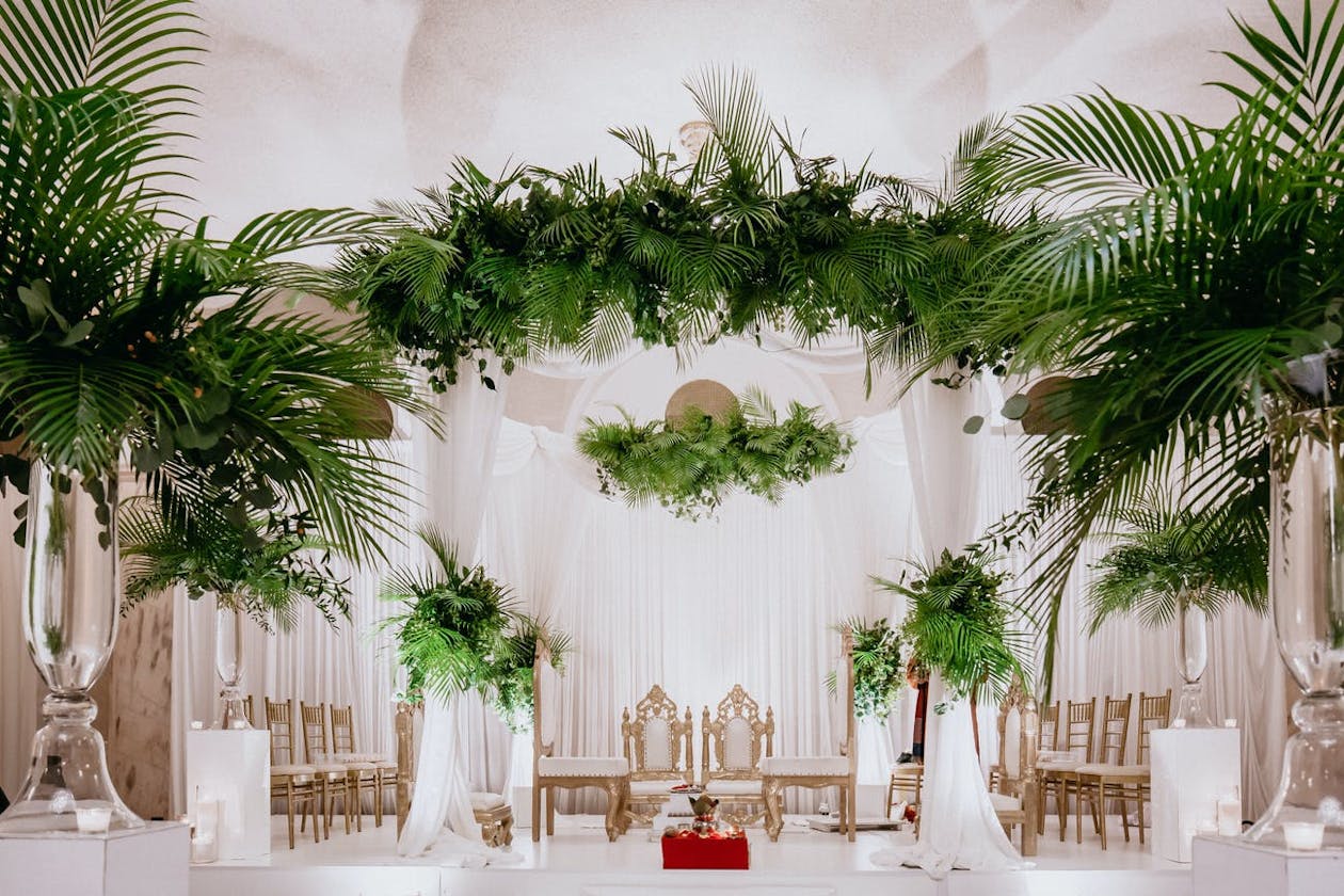 Modern wedding mandap with palm fronds | PartySlate