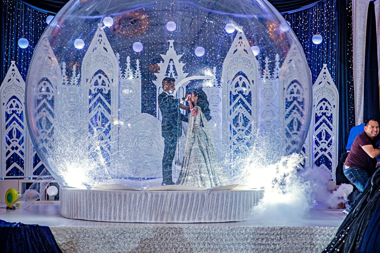 Indian wedding first dance inside giant snow globe | PartySlate